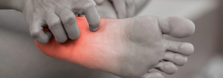 Close‑up of a person holding the underside of a foot