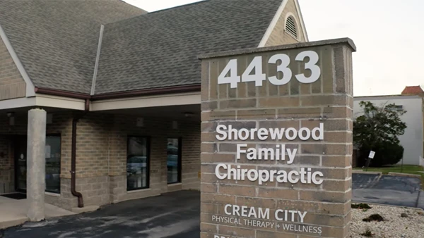 A brick building with a pitched roof and covered entrance