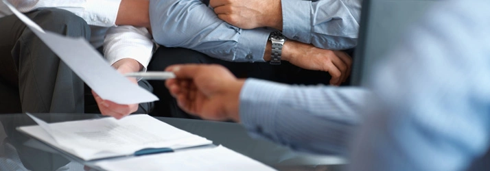 Three people looking at paperwork together