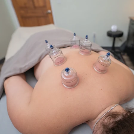 A person is lying face‑down on a massage table