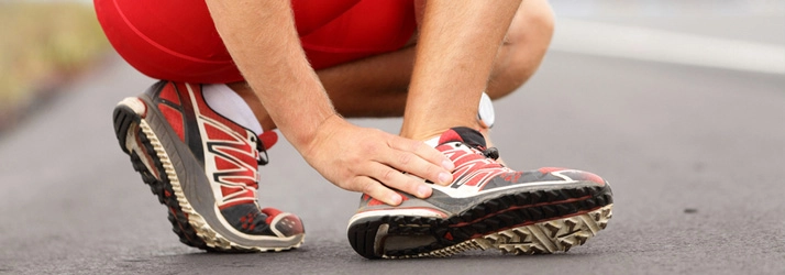 Runner holding foot in pain