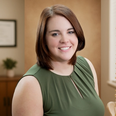 A person with shoulder‑length straight hair in a green shirt