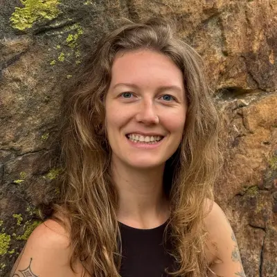 A person with shoulder‑length, long hair featuring a mix of brown and lighter tones
